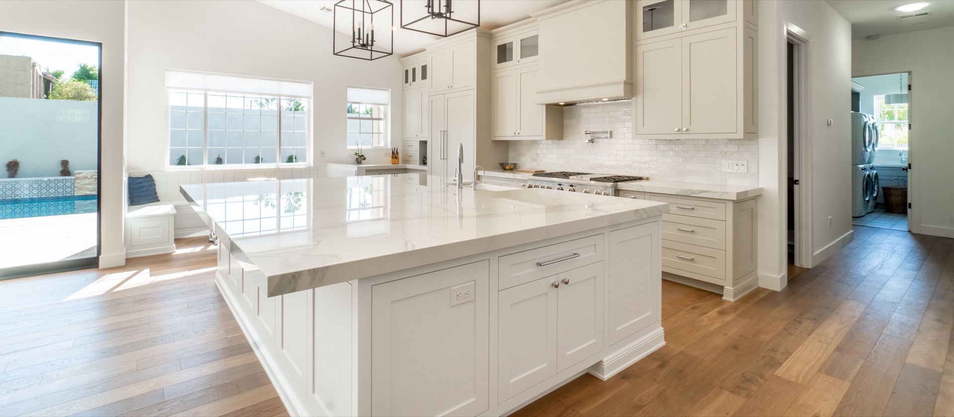 Bright modern kitchen with a white island and wide-plank oak hardwood floors